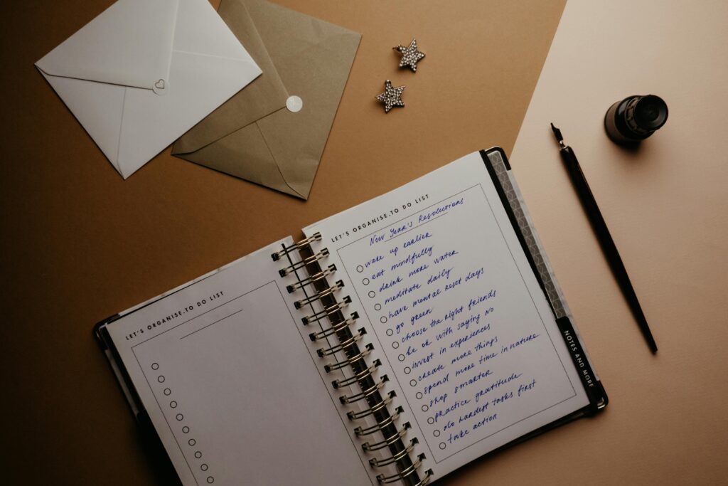 Elegant flat lay of a planner, fountain pen, and envelopes on a desk. Ideal for productivity themes.